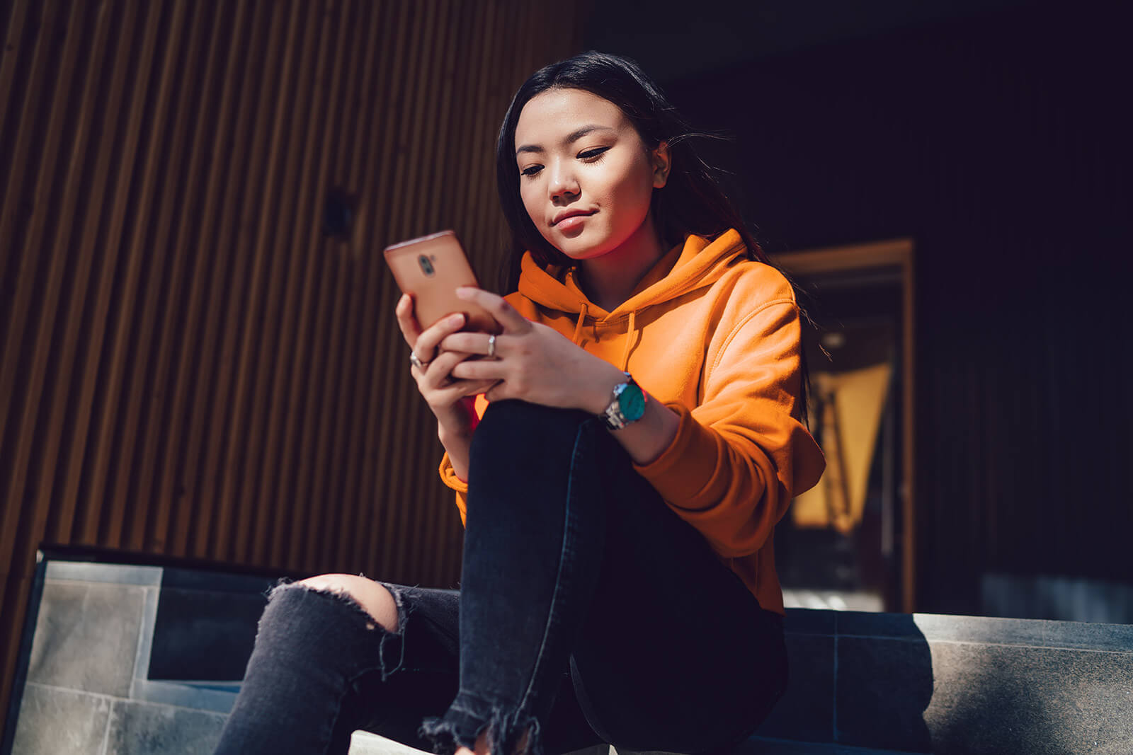 a student calculates her changes of admission on her smart phone